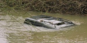 Car driving through river