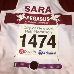 Newport Half Marathon - Sara's flat lay of race bib and garmin